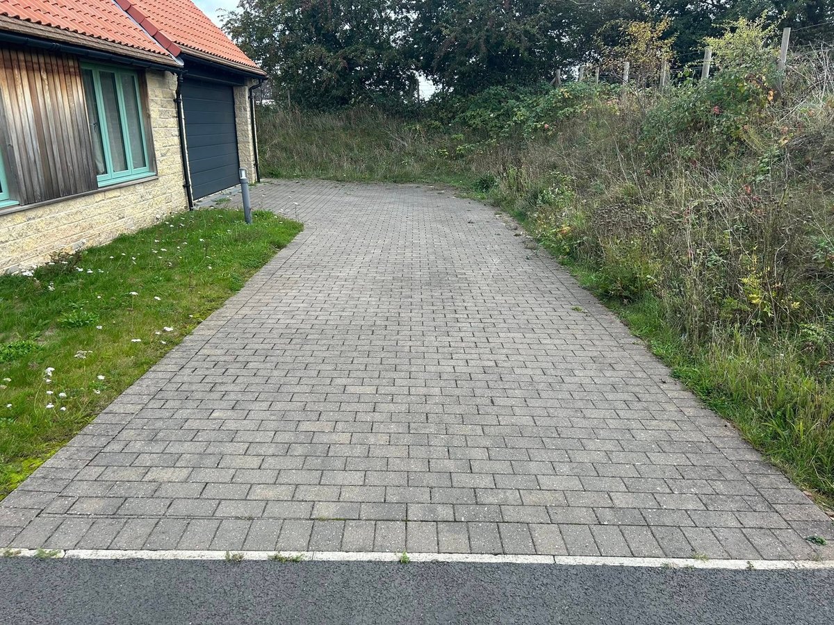 Weathered driveway before pressure washing