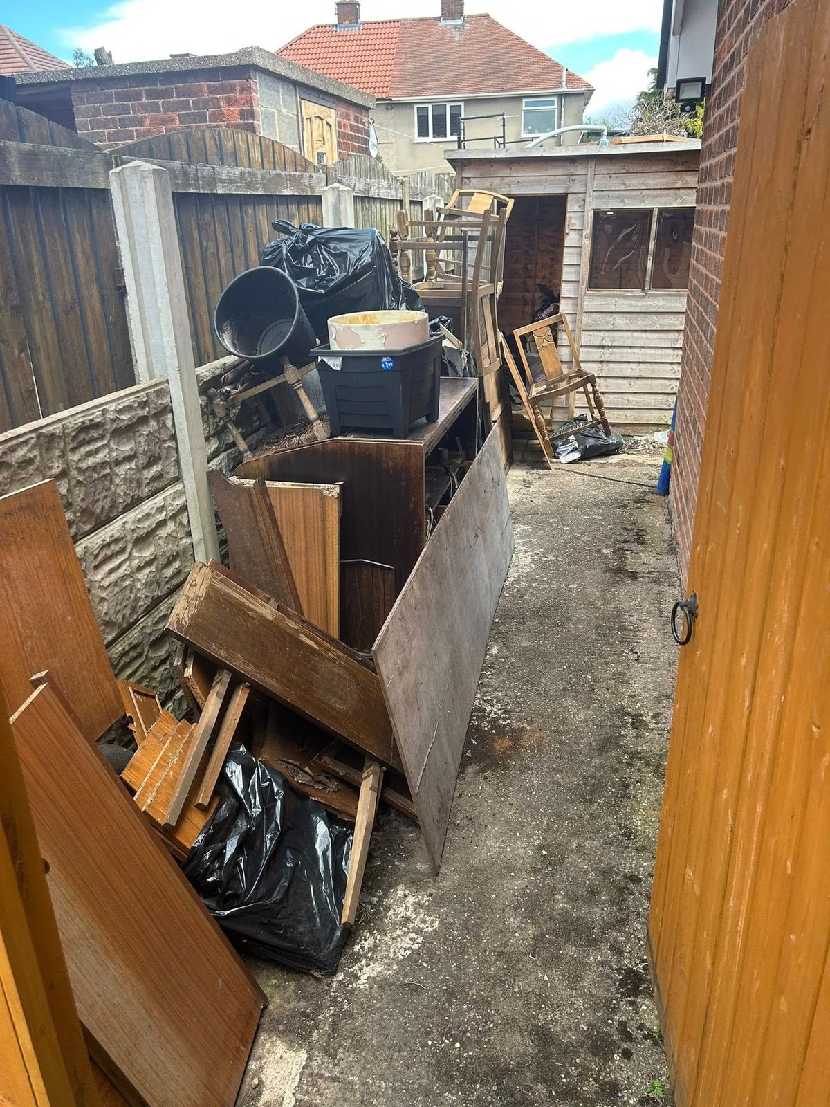 Cluttered yard with household waste before removal